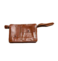a brown leather wallet on a black background