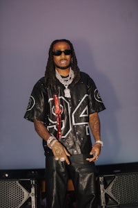 a man with dreadlocks standing on stage