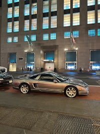 a silver car parked in front of a building
