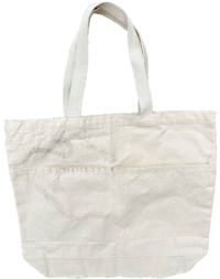 a white tote bag on a black background