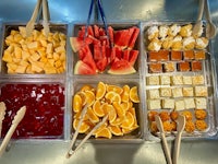a tray full of fruit and snacks