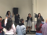 a group of people standing in front of a microphone