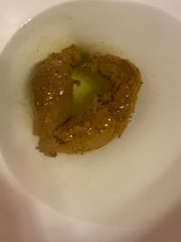 a bowl of peanut butter in a white bowl