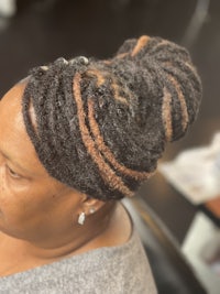 a woman with dreadlocks in her hair