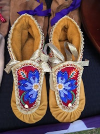 a pair of beaded moccasins on a table