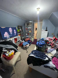 a room full of clothes and a tv