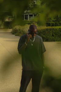a man talking on a cell phone in a park