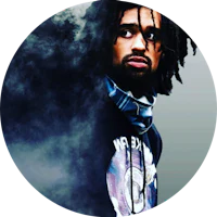 a man with dreadlocks standing in front of smoke