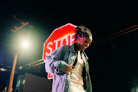 a woman standing in front of a stop sign