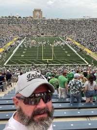 a man taking a selfie at a football stadium