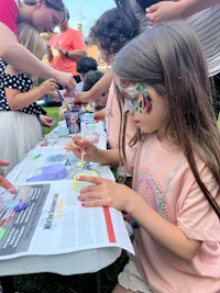 a group of children at a table looking at a map