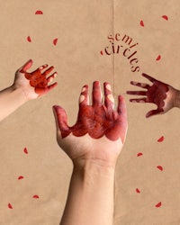 a group of hands with red paint on them