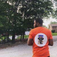 an orange t - shirt with a picture of a man on it