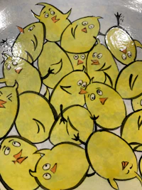 a bowl with a bunch of yellow chickens on it