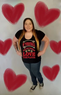 a woman wearing a t - shirt with hearts around it