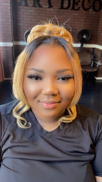 a woman in a black shirt smiling at the camera