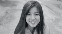 a black and white photo of a girl smiling