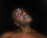 a man with a blue and silver face paint
