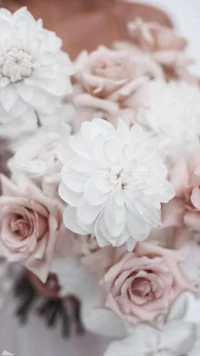 a bride holds a bouquet of white and pink flowers