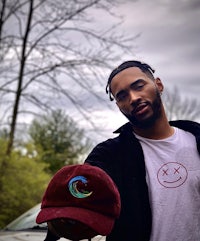 a man holding a t - shirt with a smiley face on it