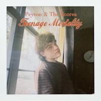 a man sitting in front of a window with the words peron & the scores