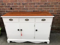 a white sideboard with two drawers and a wooden top