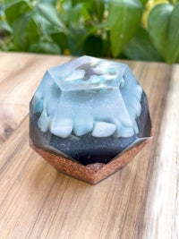 a blue and white octahedron on top of a wooden table