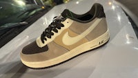 the nike air force 1 low is sitting on top of a car