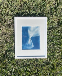 a white frame with a blue piece of paper on it