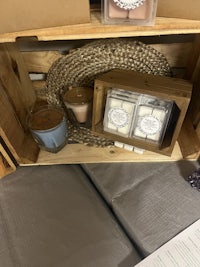 a wooden crate filled with candles and other items