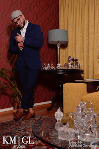 a man in a suit standing in a living room