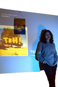 a woman standing in front of a projection screen