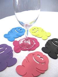 a set of colorful coasters with a glass of wine
