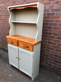 a white hutch with two drawers and a wooden top