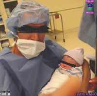 a man in scrubs holding a baby