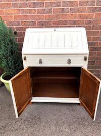 a white cabinet with a wooden top and drawers