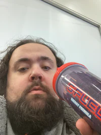 a man with a beard holding a water bottle