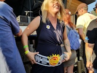 a woman wearing a sun belt at a music festival