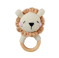 a crocheted lion on a wooden ring