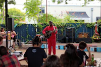 a man is playing a guitar in front of a crowd of people