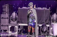 a man in a costume on stage at a concert