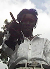 a man in a white shirt holding a peace sign