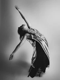 a black and white photo of a woman in a dress