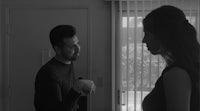 a man and woman standing in front of a door
