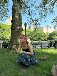 a woman crouching in the grass