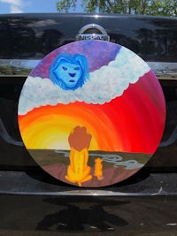 a painting of the lion king on the back of a car