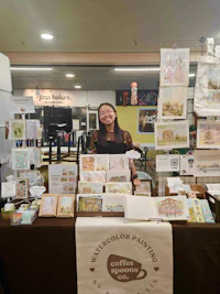a woman standing in front of a table full of cards