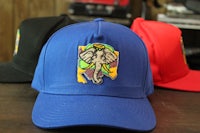 two hats with an elephant embroidered on them