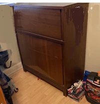 a brown dresser in a small room