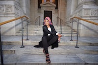 a woman sitting on the steps of a building